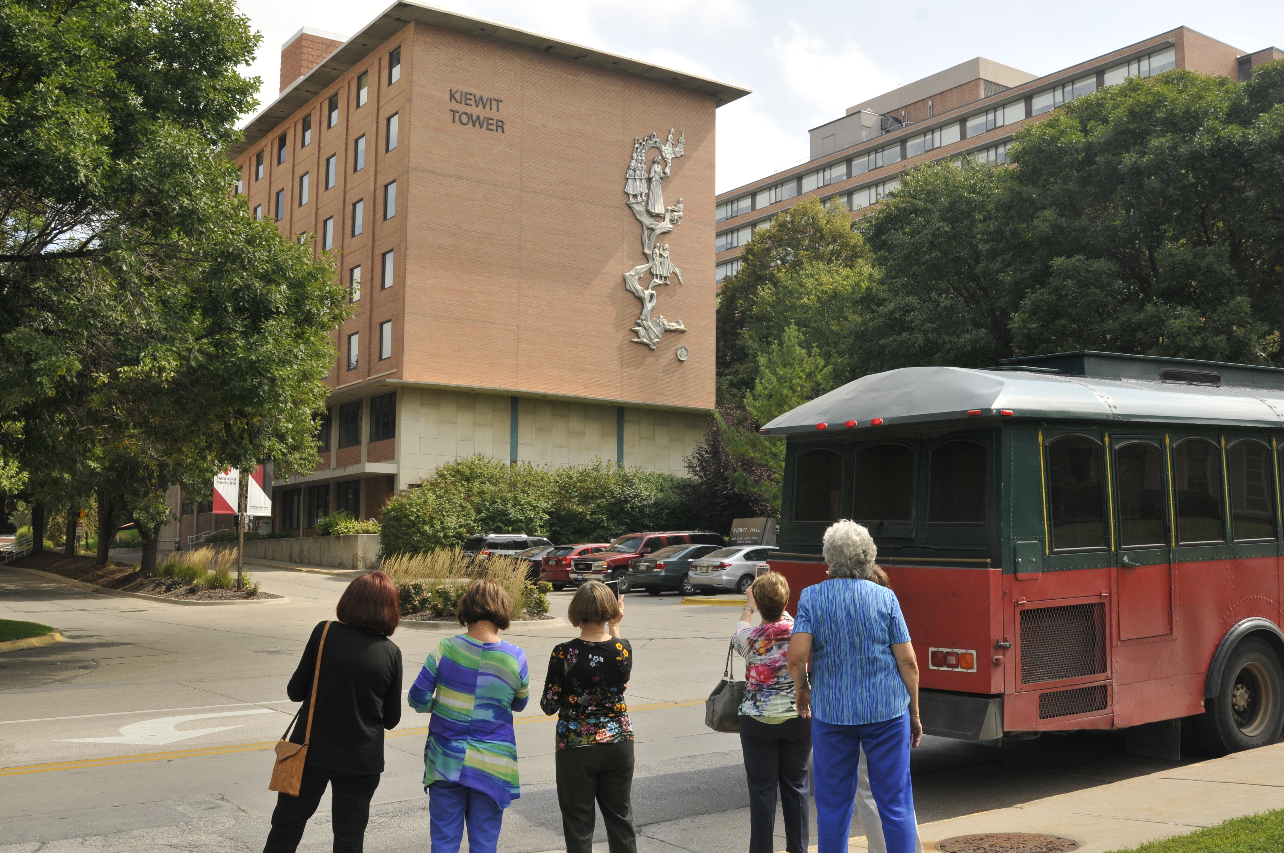 Alumni stop at Kiewitt Hall during a trolley tour through Omaha.