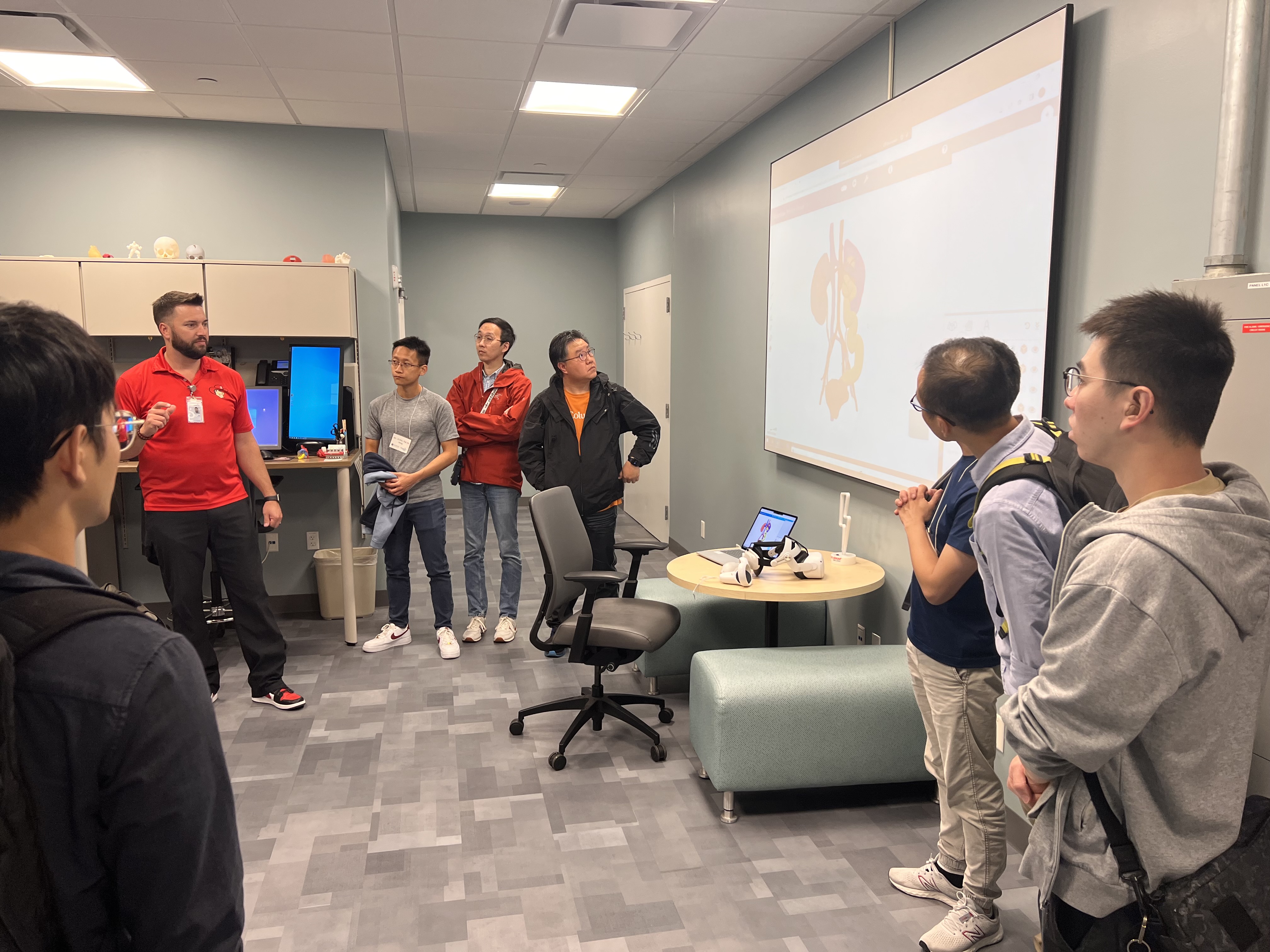 a group of people surrounding a presentation board