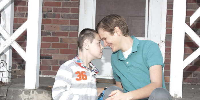 Robyn with her adopted son in the front of their home